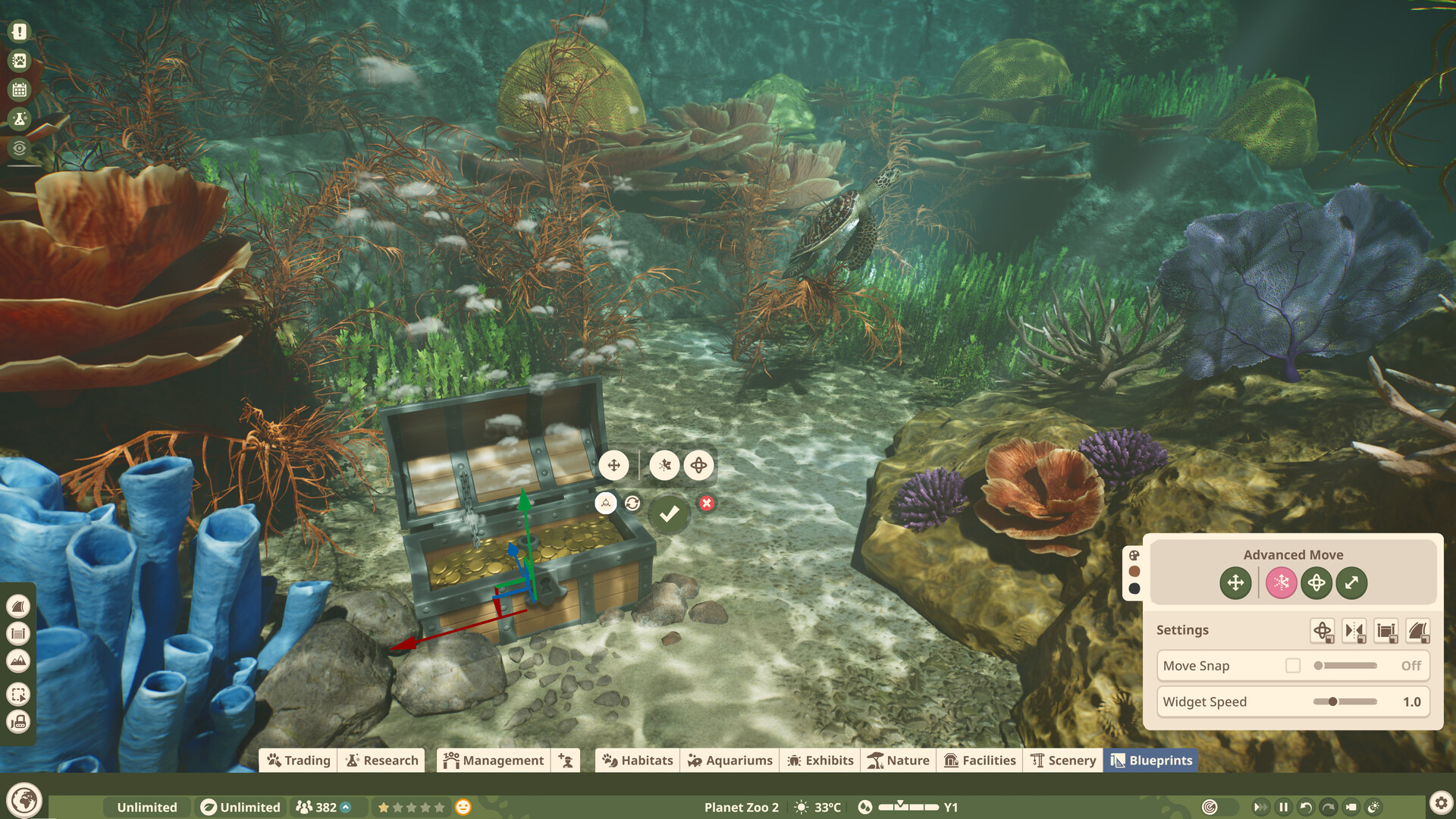 Scenery being placed on an aquarium seafloor among coral and sponges while a hawksbill turtle swims past