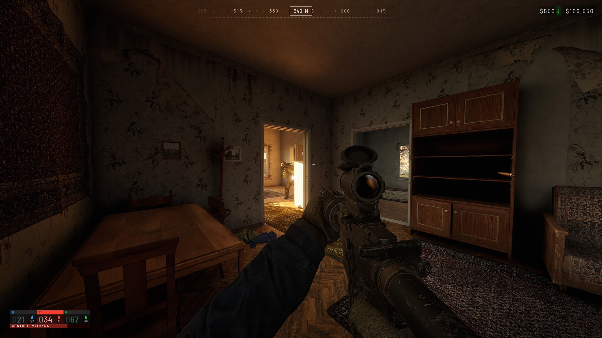 A first-person WARDOGS view clearing a village house interior with an enemy silhouetted in a lit doorway