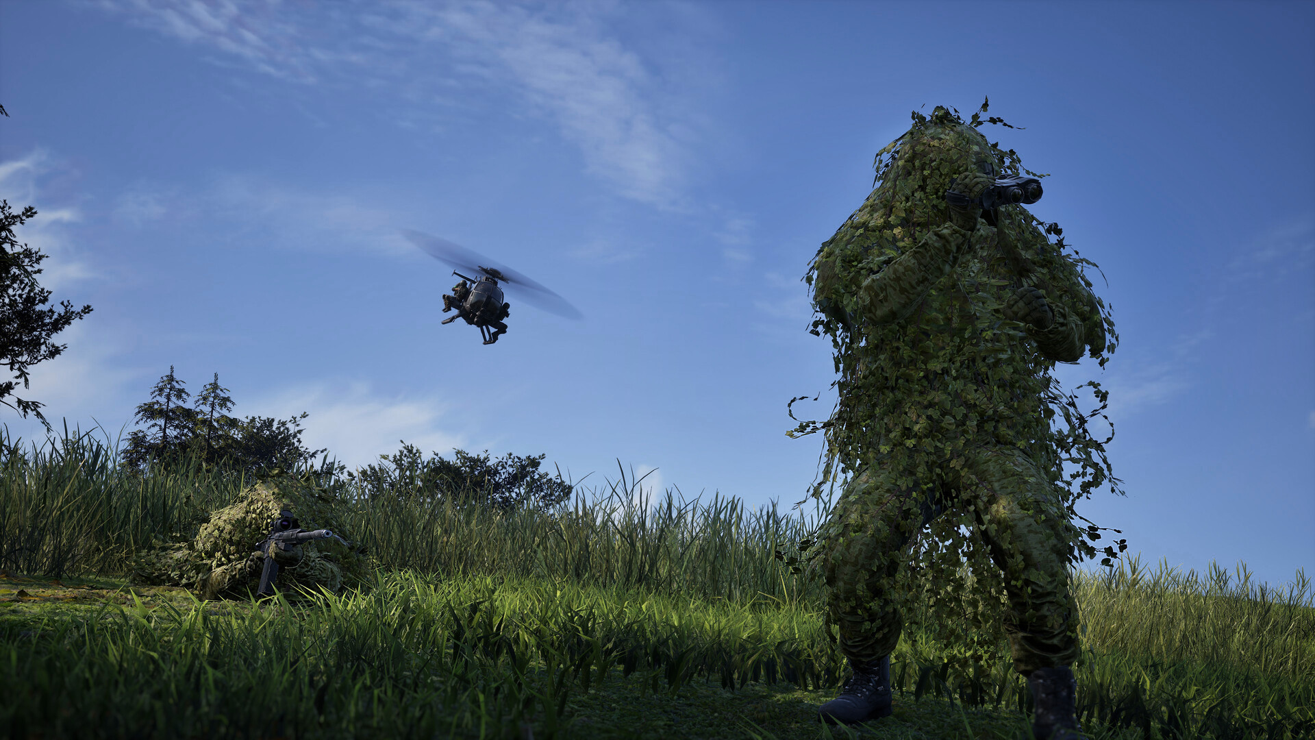 A WARDOGS spotter in a leafy ghillie suit glasses through binoculars while a prone marksman in matching camouflage covers the field, a light helicopter passing overhead