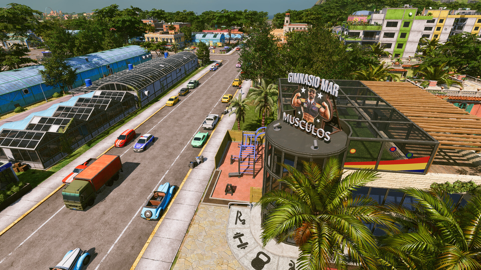 Tropico 7 city avenue with traffic beside greenhouses and a gym building