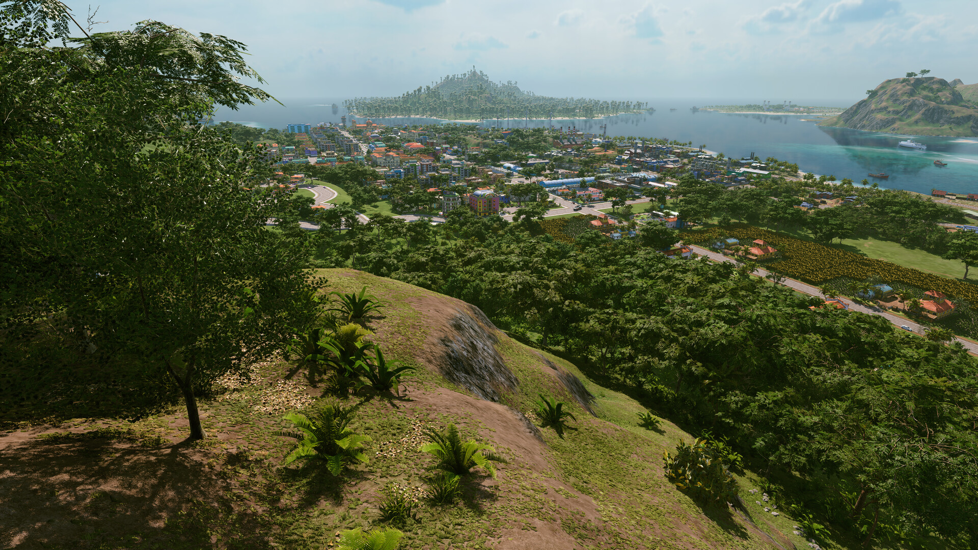 Tropico 7 view from a forested hilltop over a coastal town and neighboring islands