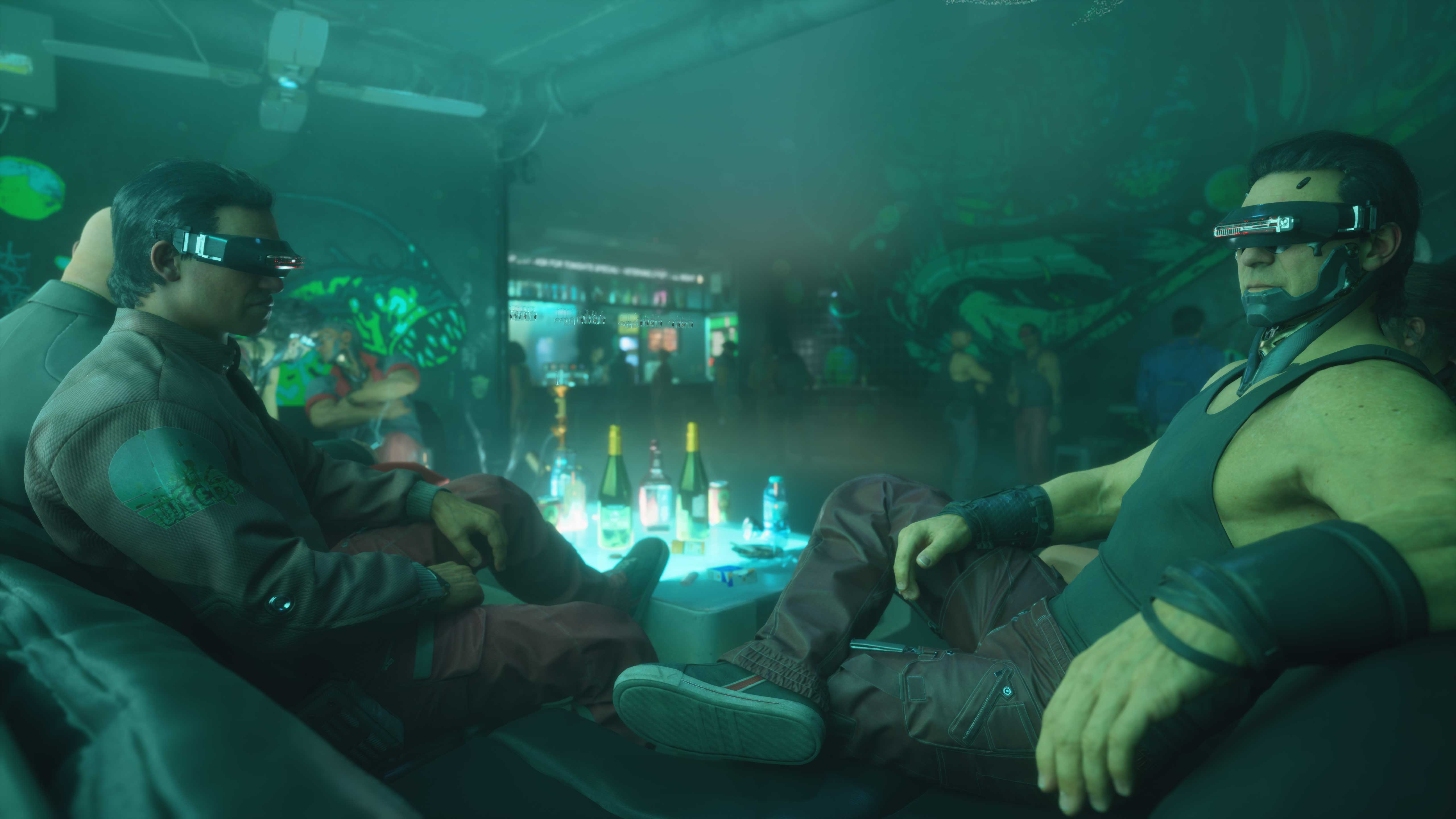 Two Fishbone Gang members lounging in a green-lit Port Desire bar, wearing visor eyewear beneath painted fish murals
