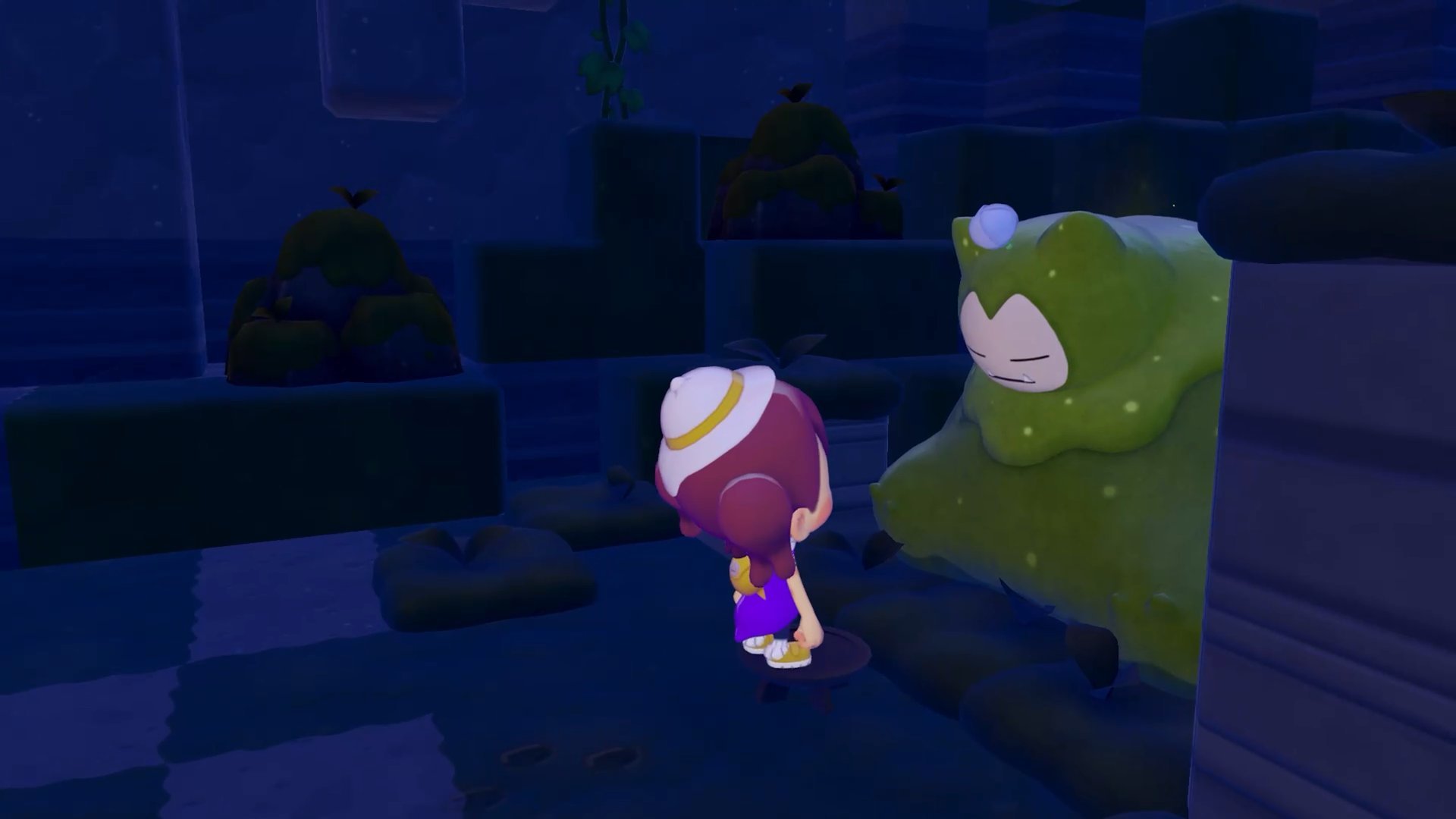 A player standing beside a massive sleeping Snorlax blocking a path at nighttime in a dark area