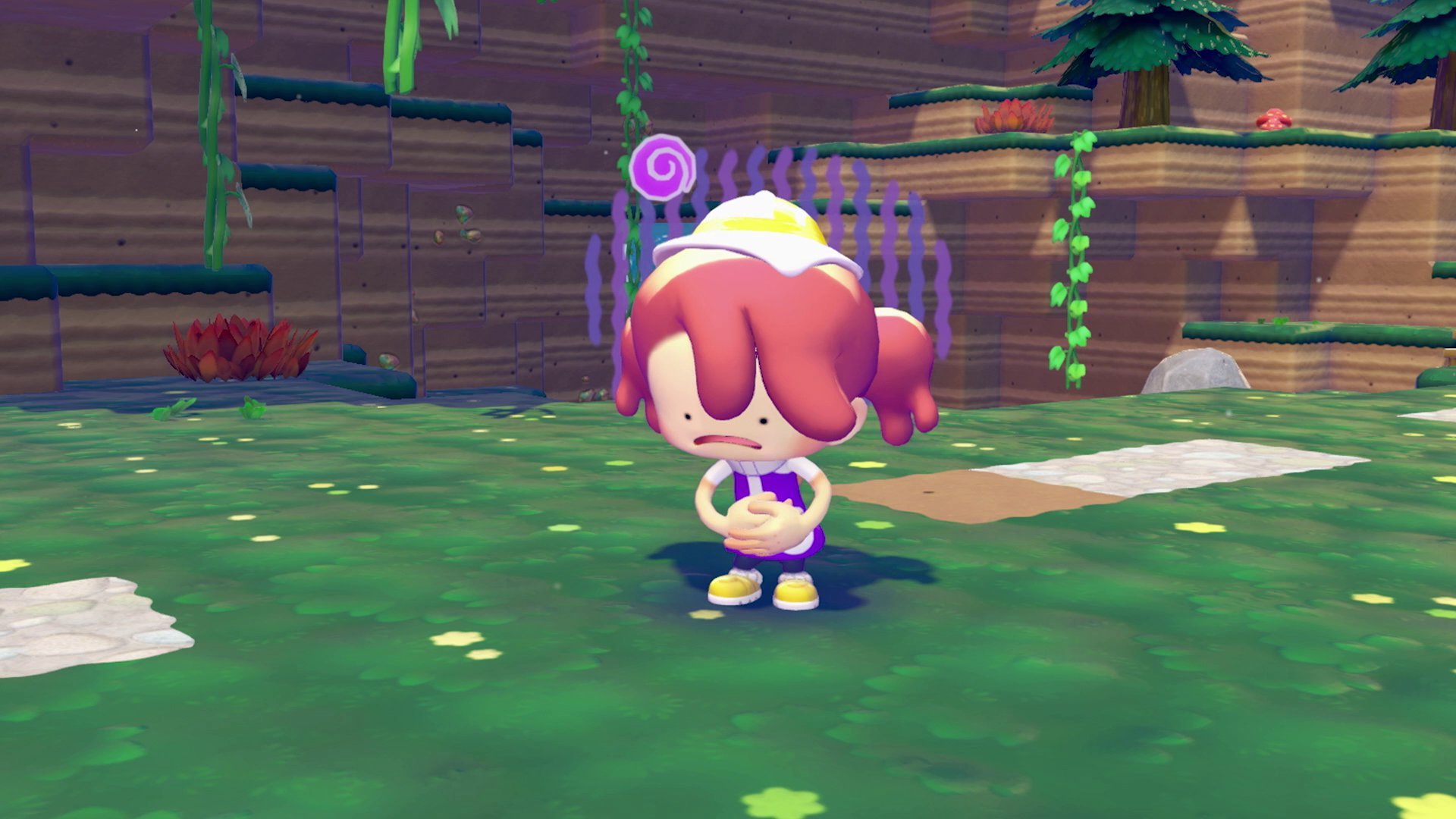Player character showing a tearful expression in a lush green area with fences and lollipop decorations
