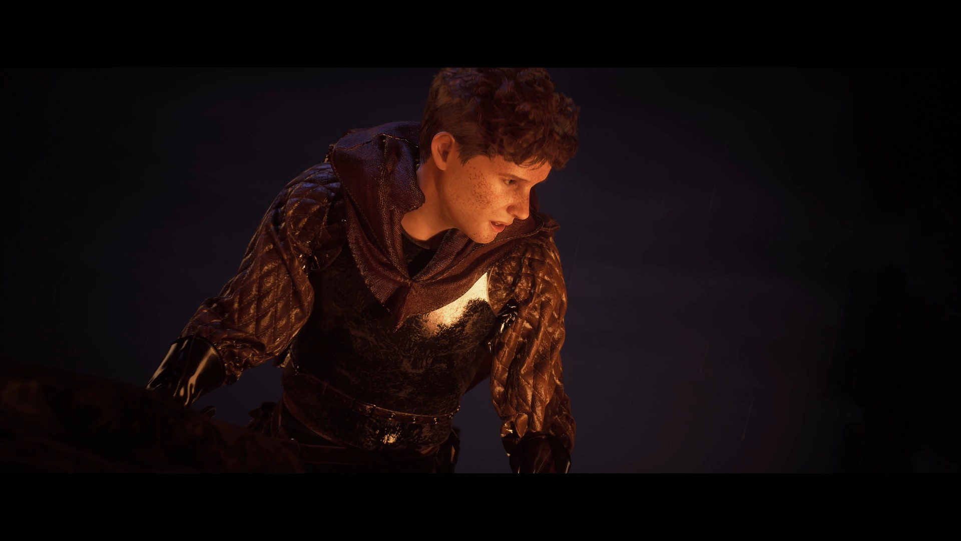 Stronghold 4 cinematic still: a freckled young man in quilted armour and gauntlets leans forward in the rain, lit from below by firelight