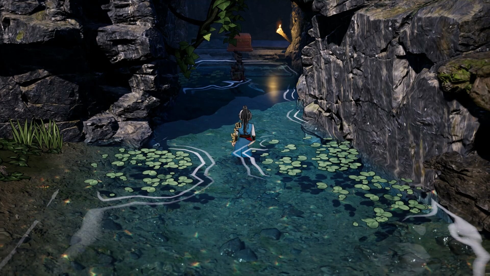 A narrow rock gorge with clear shallow water, lily pads and a small shrine at the far end, a single figure wading upstream.