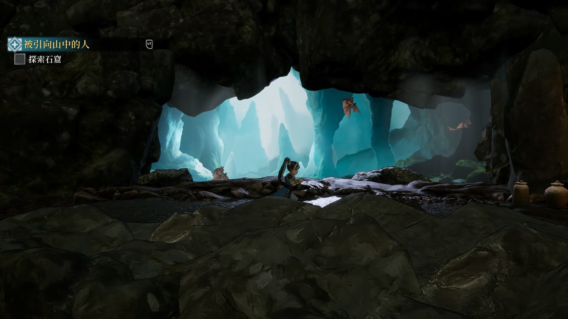 The mouth of a cave opening onto pale blue ice formations, with a quest objective tracker shown in the upper left corner.