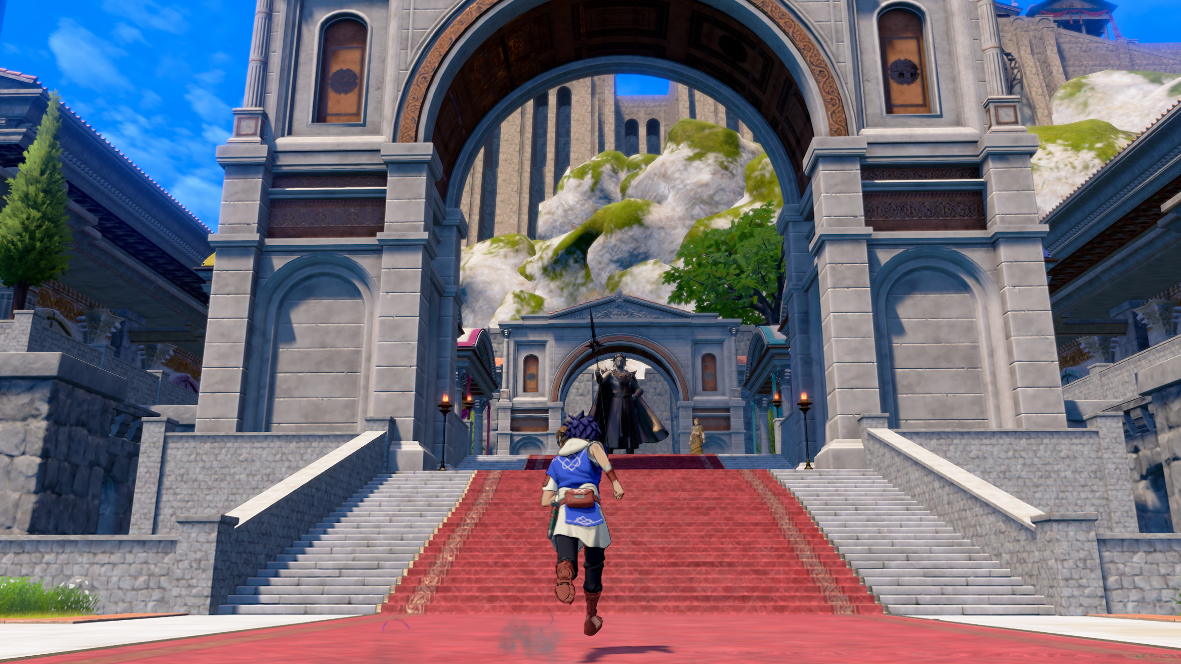 Running up a red carpet toward a stone triumphal arch guarded by an armoured statue