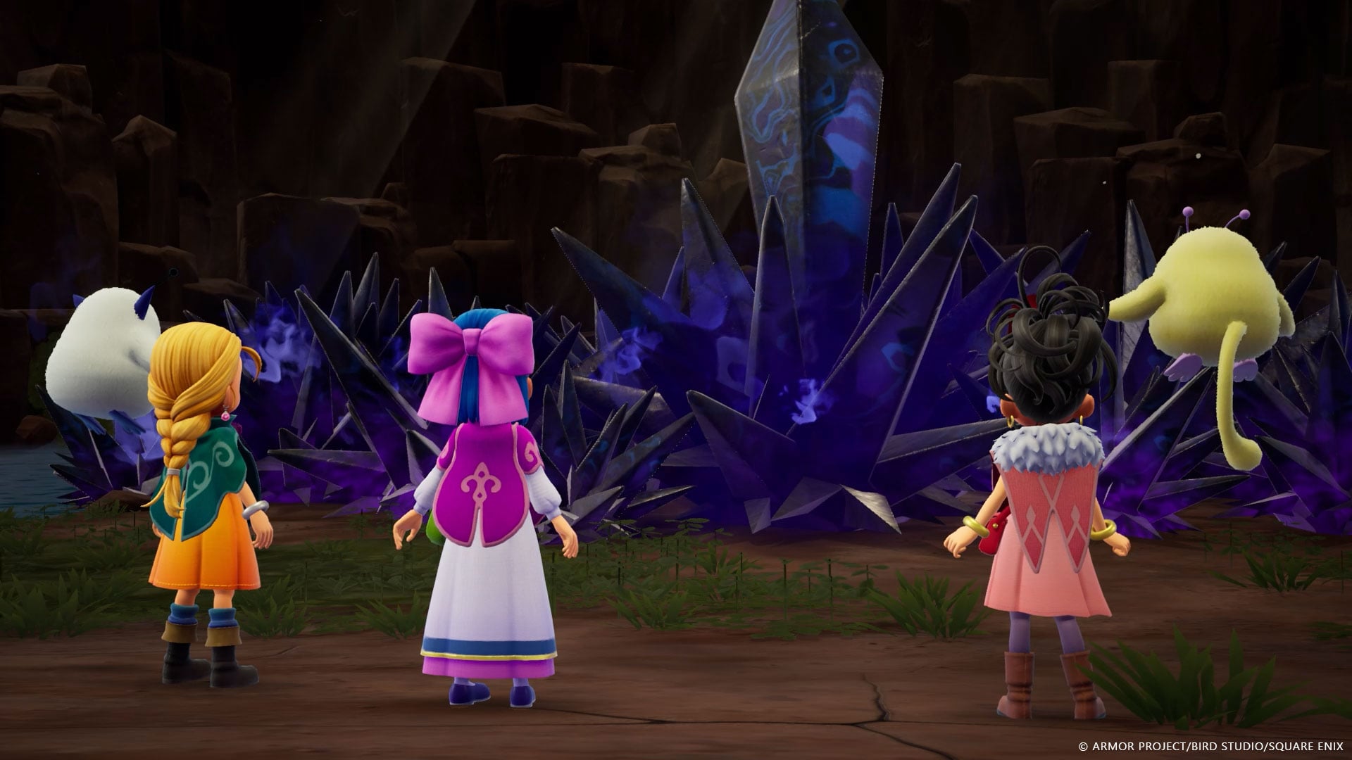 A towering mass of jagged dark violet crystal wreathed in purple mist inside a rocky cavern, with the two protagonists, a companion and two monsters standing before it
