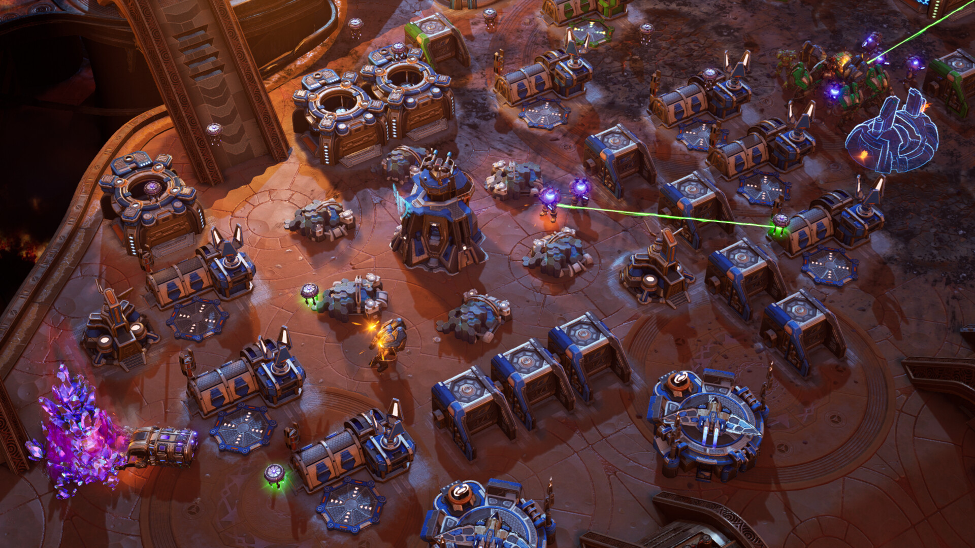 Large fortified base of production structures and turrets on red rock, built out around a purple flux crystal outcrop worked by an extractor