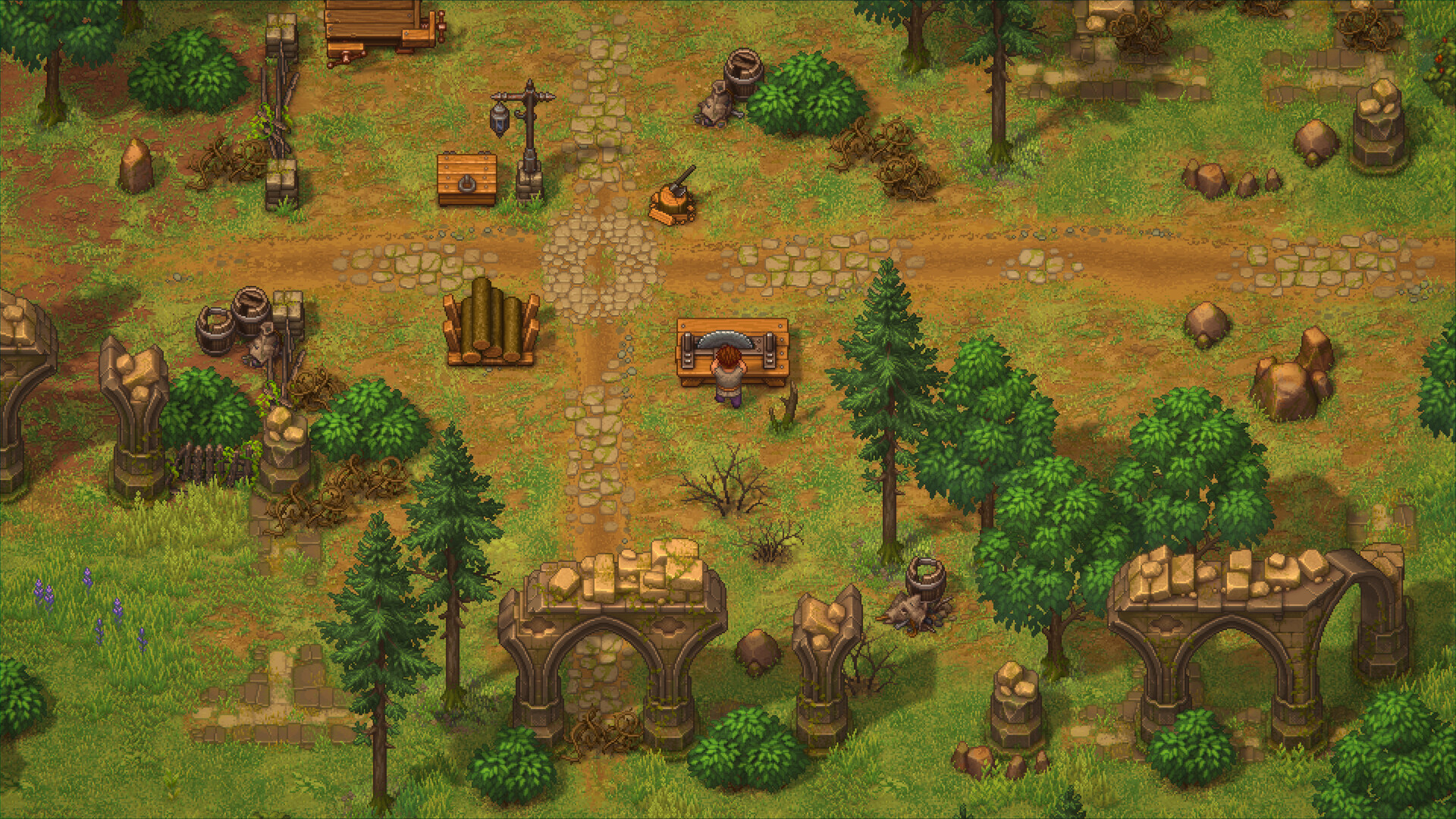 Graveyard Keeper 2 demo screenshot of the Keeper working a two-handled saw bench in an outdoor clearing, next to a log pile, a chest, a lantern and barrels among ruined stone arches