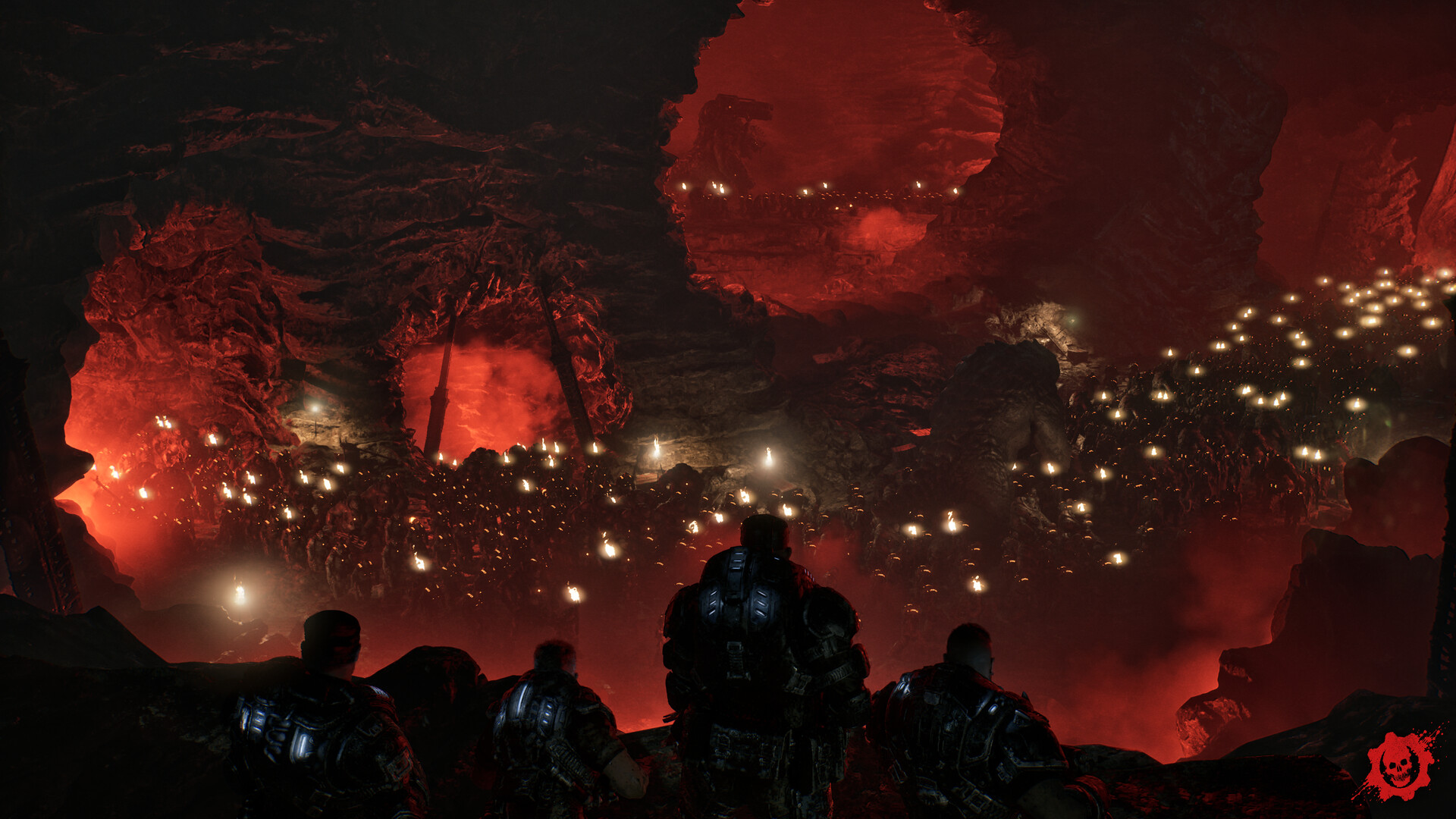 Four Gears look down from a ledge over a vast underground cavern filled with a torch-lit Locust army