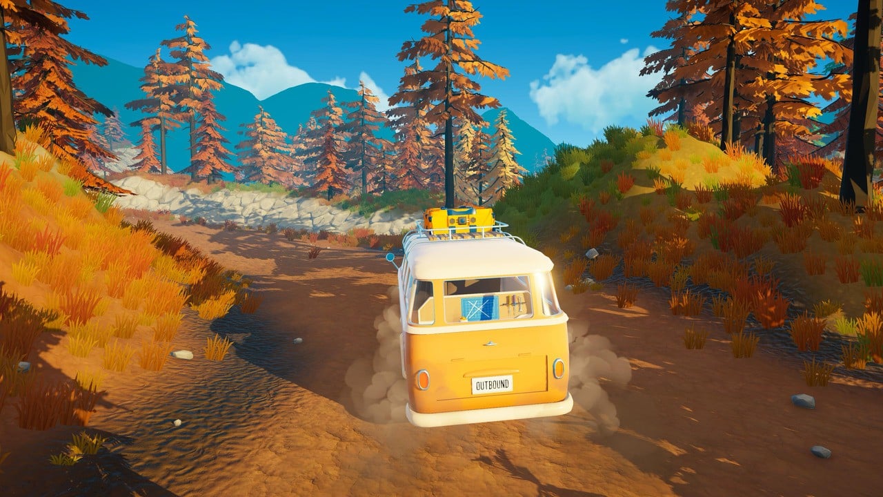 Camper van driving through an autumn forest road in Outbound