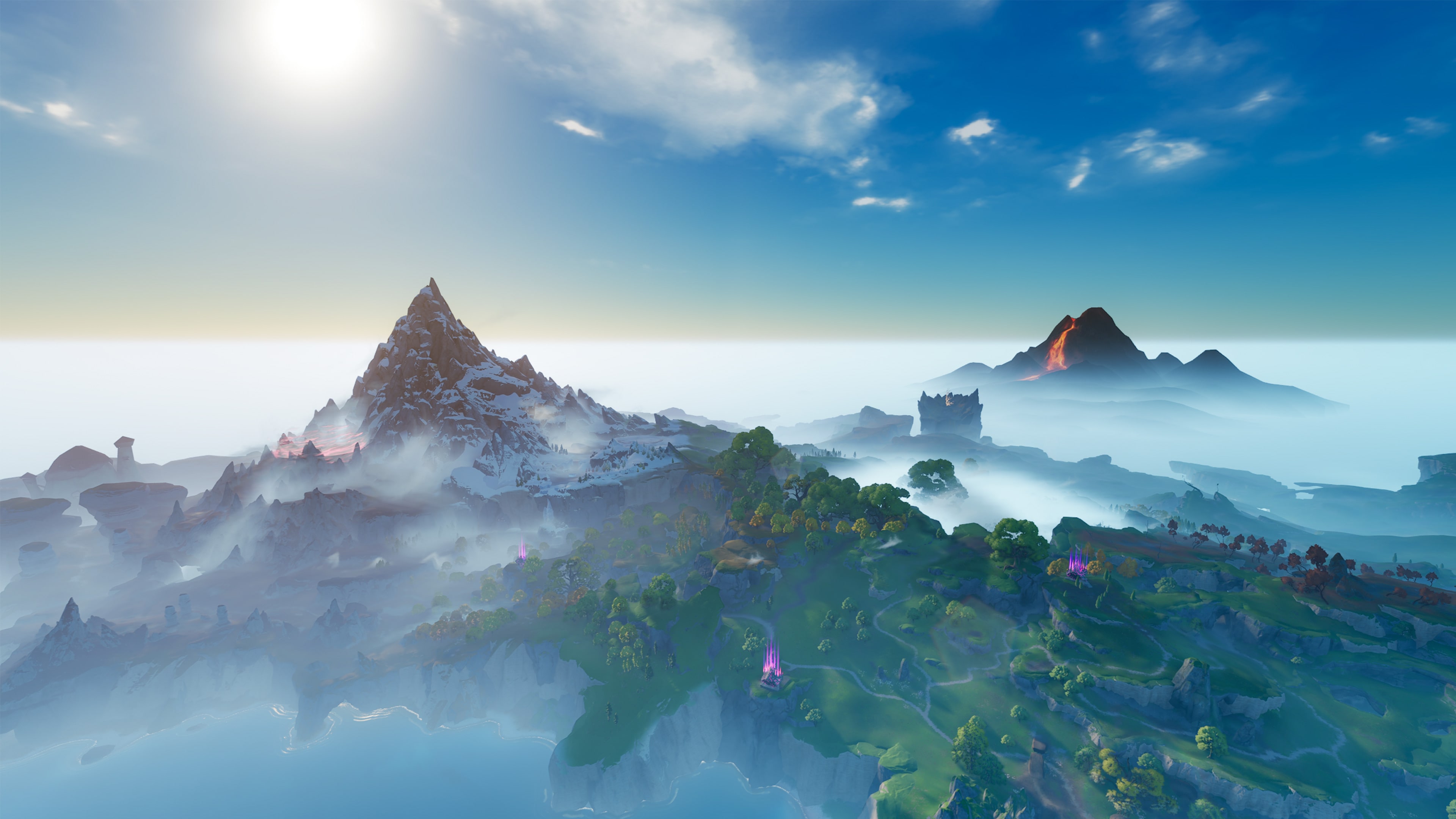 A wide view across a misty valley toward a distant volcano and snow-capped peaks