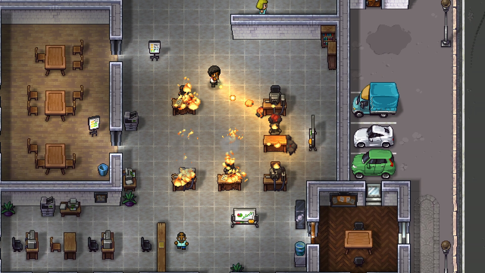 An office building interior on fire in Streets of Rogue 2, where a character fires a weapon across an open-plan floor as desks burn, with meeting rooms, whiteboards, photocopiers and cubicles around them and a street of parked vehicles outside