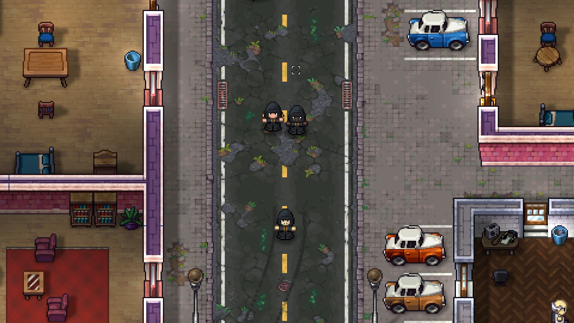 A cracked, weed-grown road running between run-down buildings in Streets of Rogue 2, with three NPCs in black hooded robes standing in the roadway, a furnished shop interior on one side and pickup trucks parked on the other