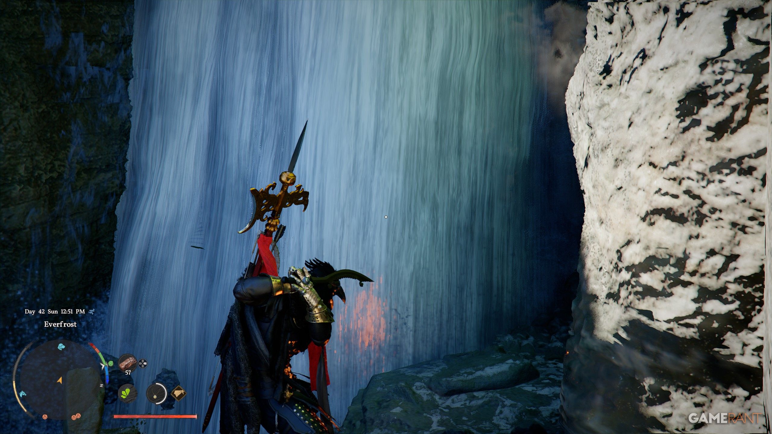 Waterfall cave entrance with stacked stones marking the hidden passage in Crimson Desert