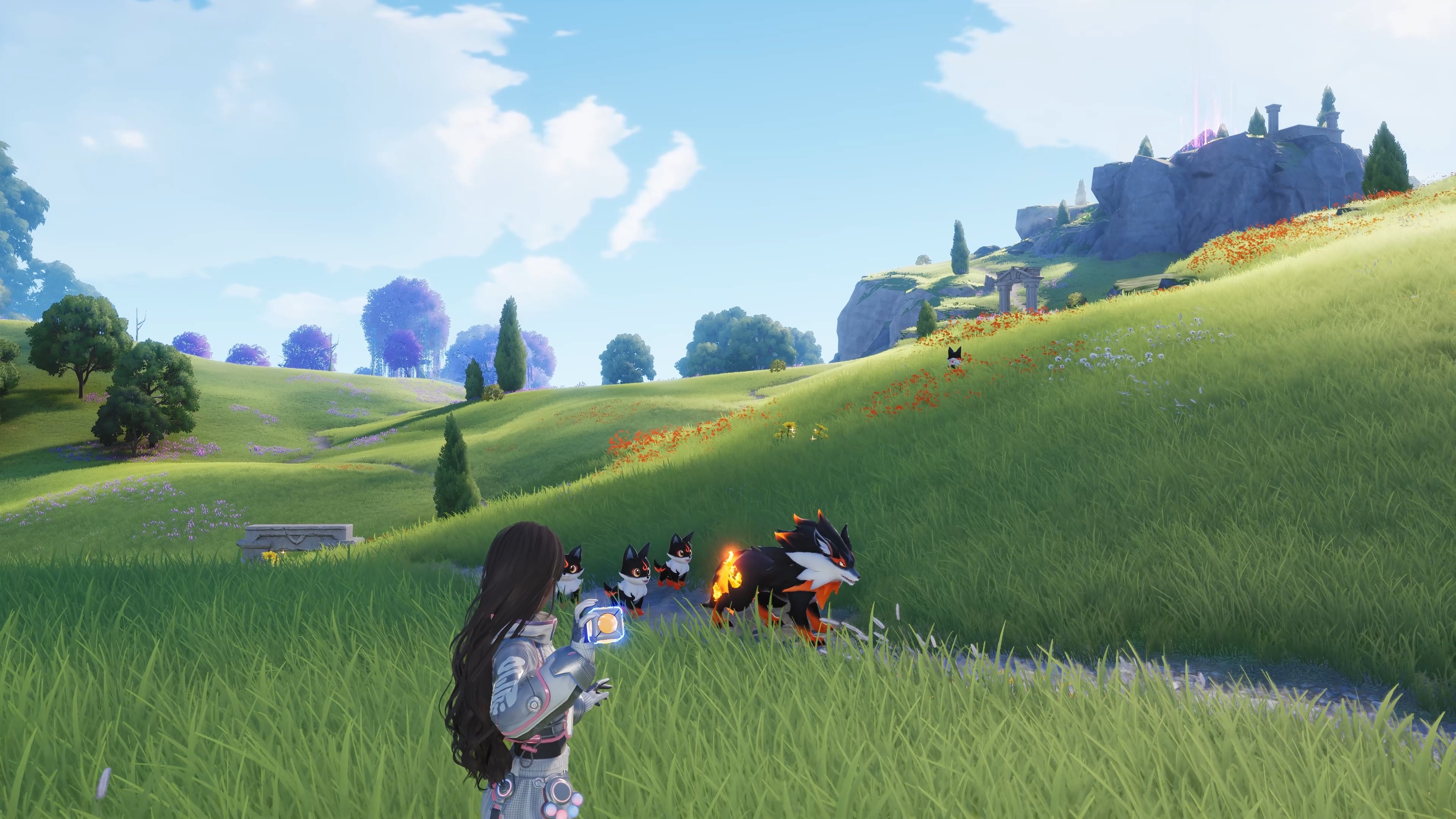 A Pathfinder gathered with a group of small Aniimo on a rolling green hillside under a clear sky