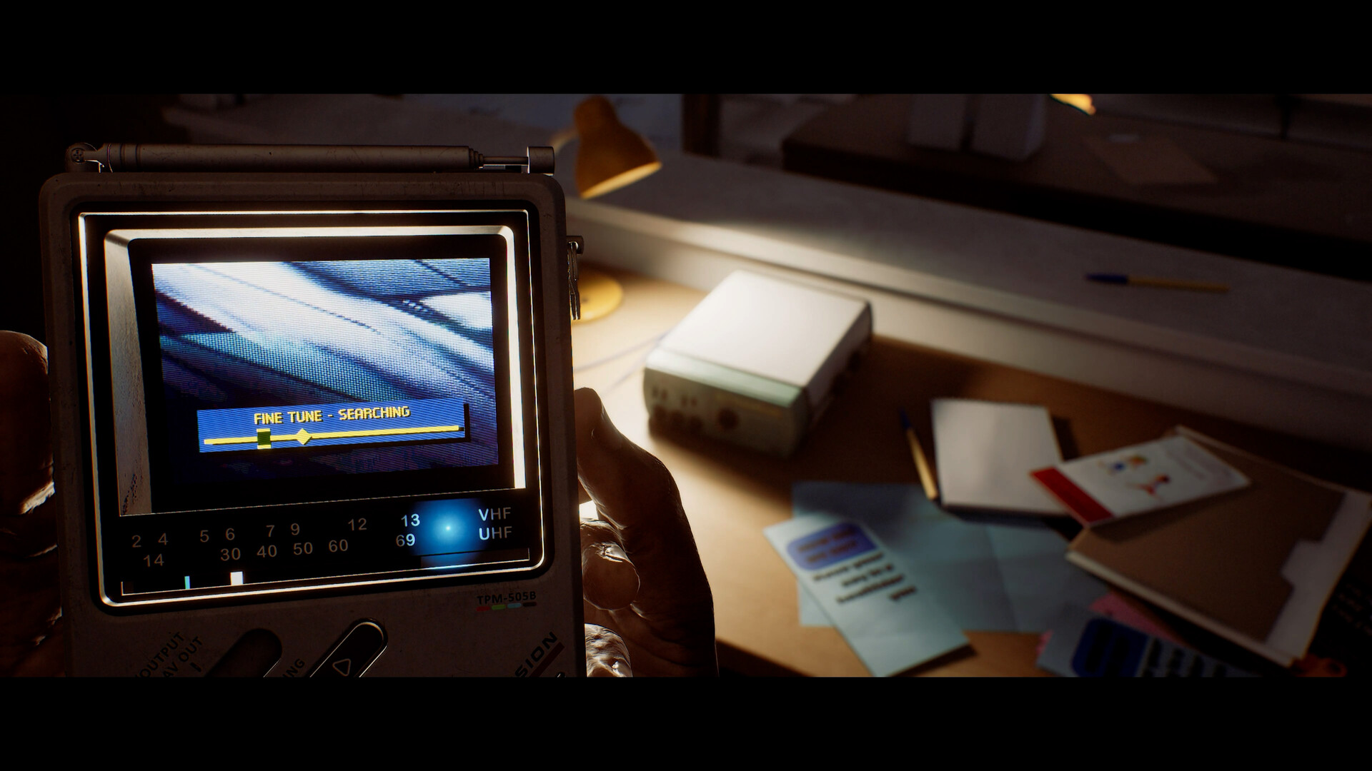 The CRTV resting on a desk, displaying its fine tune searching screen