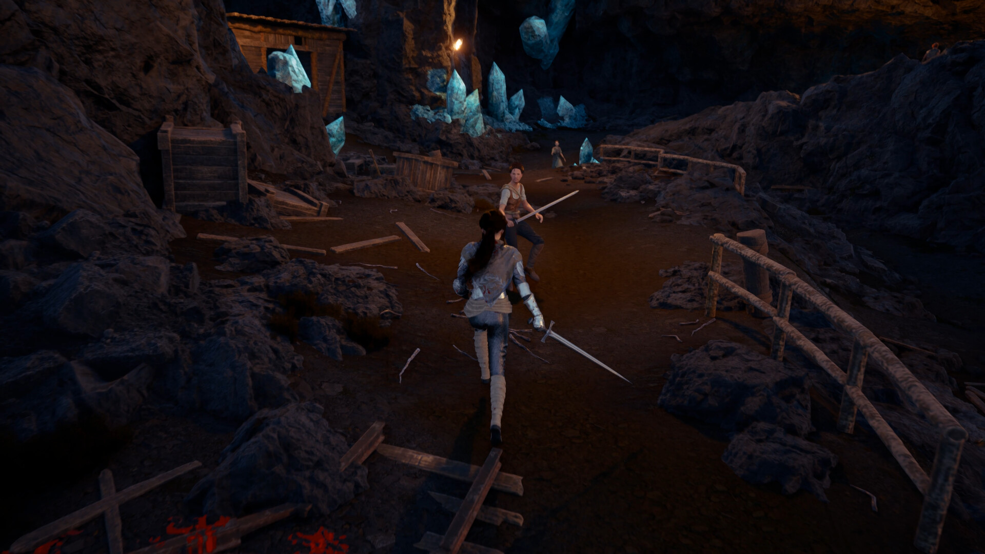 A sword-wielding character fights an enemy in a cave lit by blue crystals
